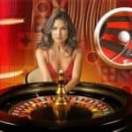 banner image of a roulette table with a female croupier, dressed in a red dress. The background is also red.