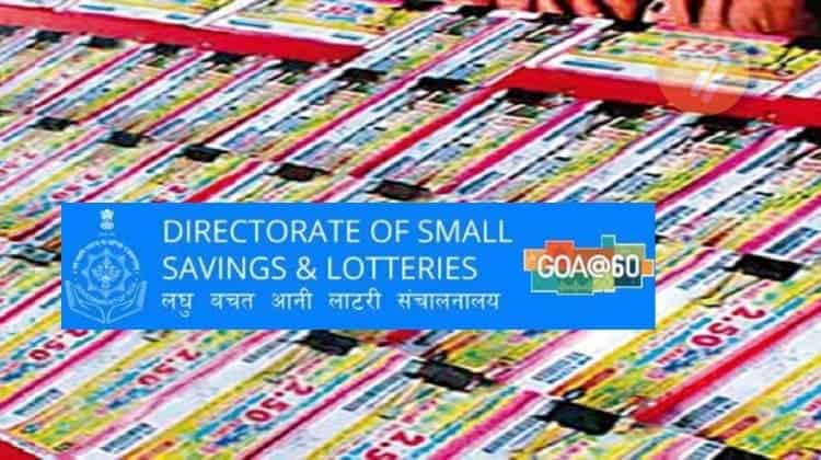 The emblem of the Directorate of Small Savings & Lotteries on the background of a stand with paper-back lottery tickets.